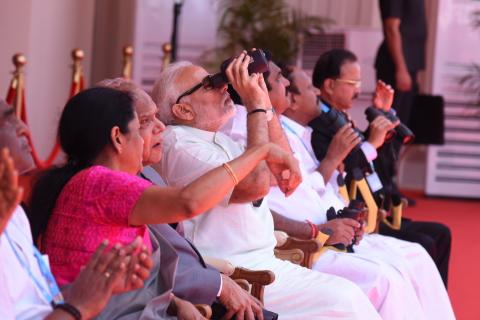 PM Narendra Modi watches the live demonstration through binoculars at DefExpo India 2018