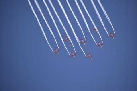 The Indian Air Force's aerobatic team Suryakiran performs maneuvers during Aero India 2023.