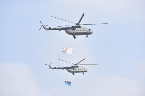 Indian Air Force helicopter aerobatic performance with the displayed Aero India flags at the launch of Aero India 2023.